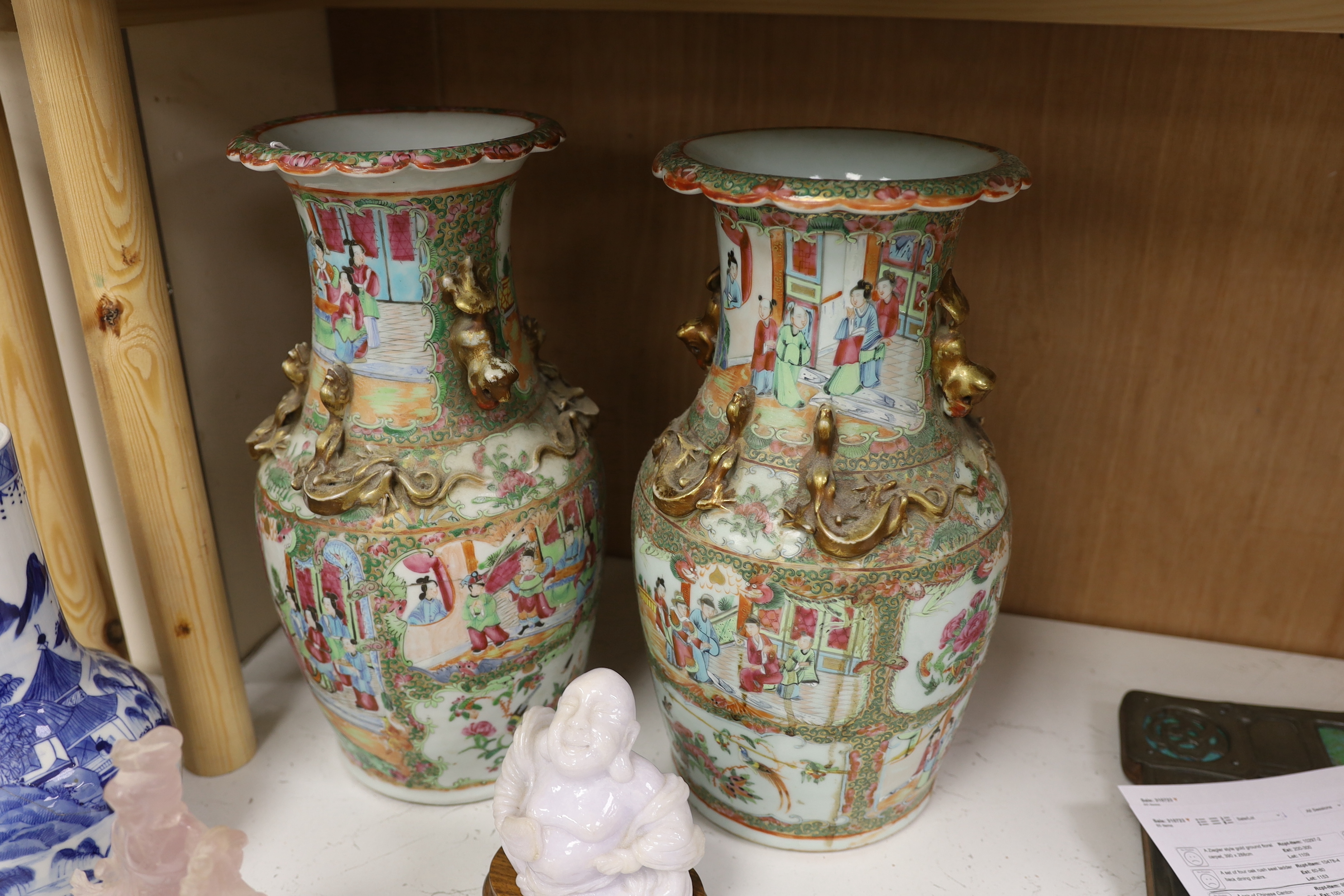 A pair of Chinese Canton decorated famille rose enamelled vases, 36cm high